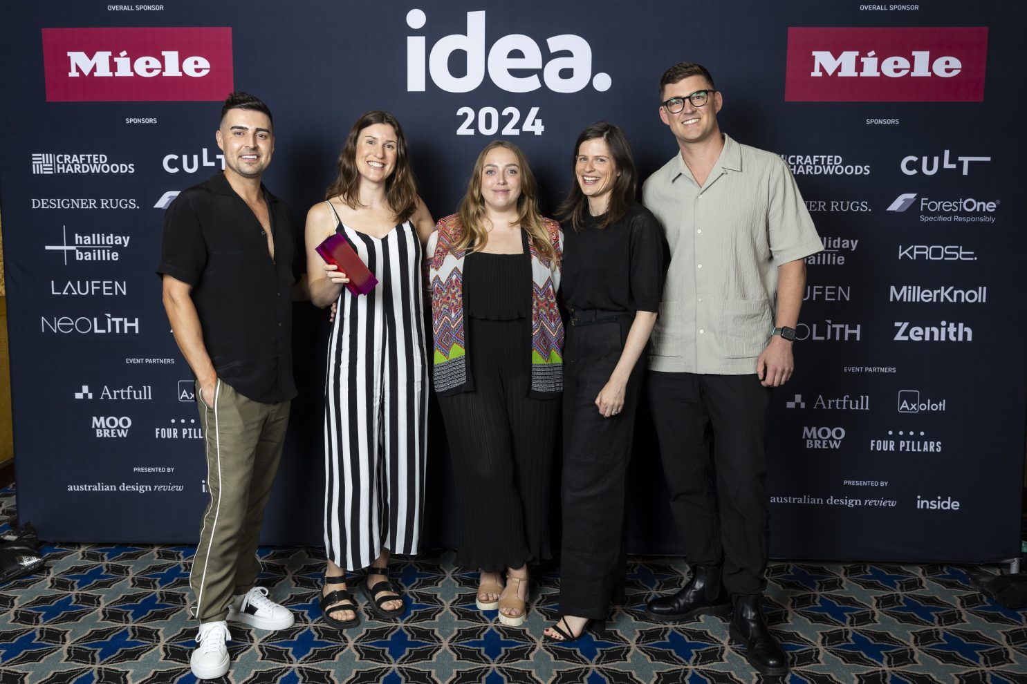 Catherine Keys, Alecia Mostert and Emily Clarke (second left, middle, and second right) celebrate the win at the IDEA Gala. Photography by Scott Gick.